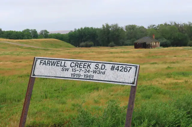 Farwell Creek School District sign and abandoned schoolhouse